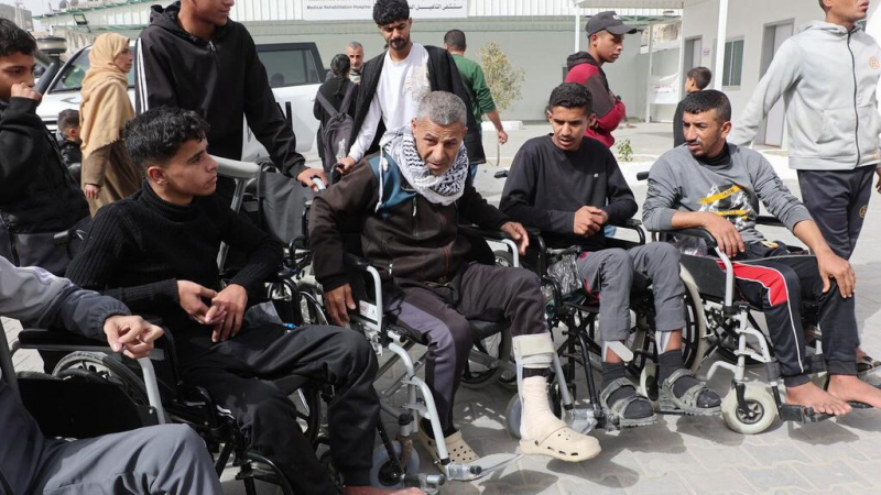 Injured Palestinians in wheelchairs protest demanding permission to travel abroad for medical treatment.